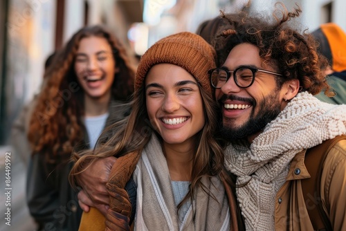 A group of friends laugh together while walking down a lively street, wrapped in warm clothes, showing the joy and connection shared in friendships. photo