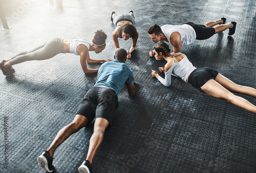 Fotografie People, training and plank in group at gym for workout, core exercise or fitness together indoors