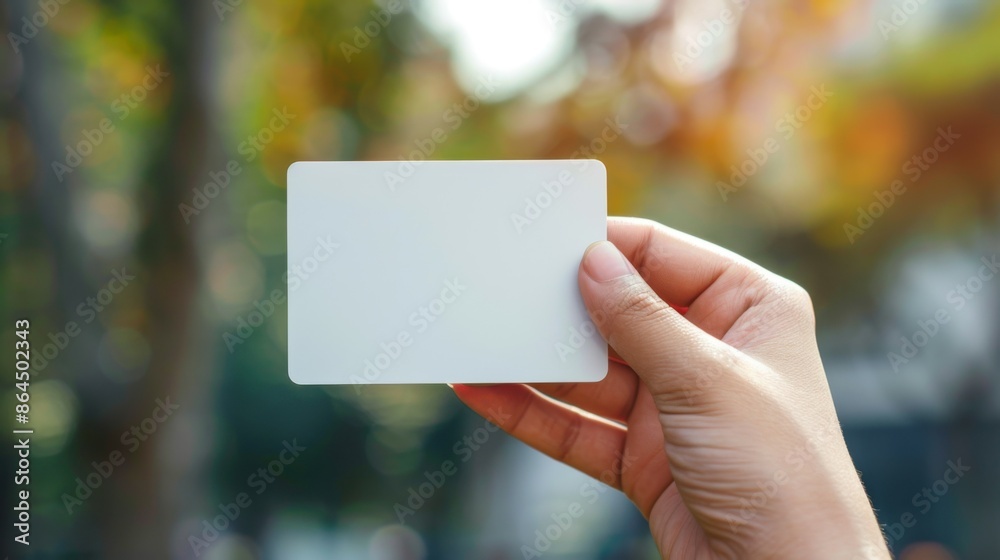 Hand holding white rectangular card with space for text Hand holding white rectangular card with space for text