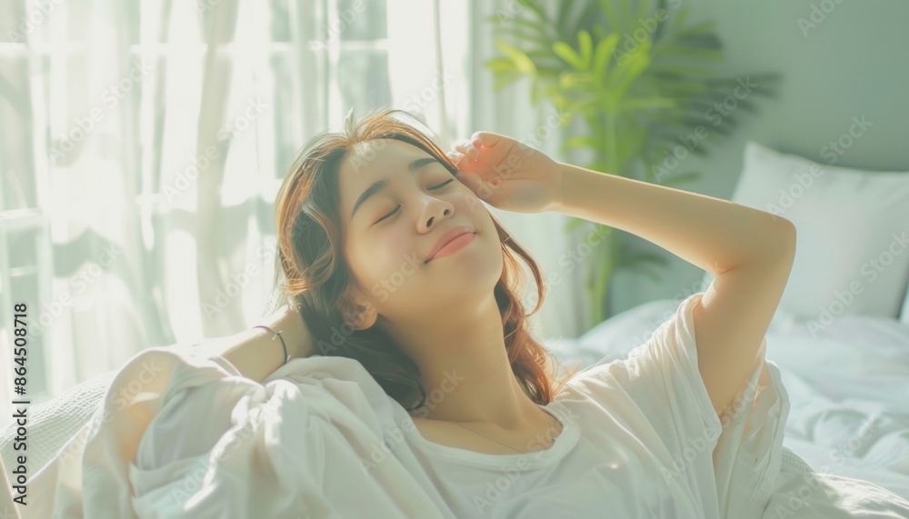 Woman Relaxing In Bed With Her Eyes Closed In The Morning Sun