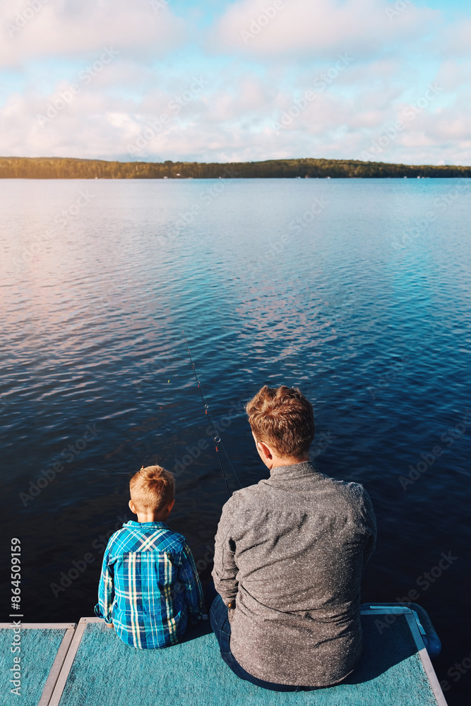 Fototapeta premium Fisherman, child and back view of lake in summer for vacation, together and relax in morning. Family, father and kid in nature by water for holiday, learning or gear for outdoor adventure with dad
