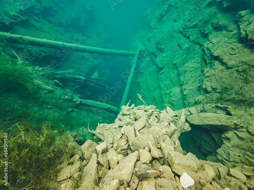 underwater photography of a karst cave on Glebina Lake, cold clear water, Sarva spring, Bashkortostan, Russia, stone debris under water. photo