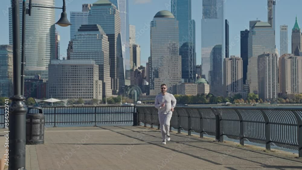 Running man in Manhattan. Morning sport workout jogger run in New York. The jogger run at sport training. Sportsman jogger running. Man in sports suit training. Jogger Fitness Sport Running man in Manhattan. Morning sport workout jogger run in New York. The jogger run at sport training. Sportsman jogger running. Man in sports suit training. Jogger Fitness Sport