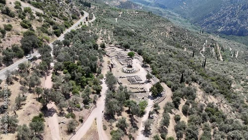 Aerial bird's eye view video taken by drone of archaeological site of ancient Delphi, site of temple of Apollo and the Oracle, Voiotia, Greece photo