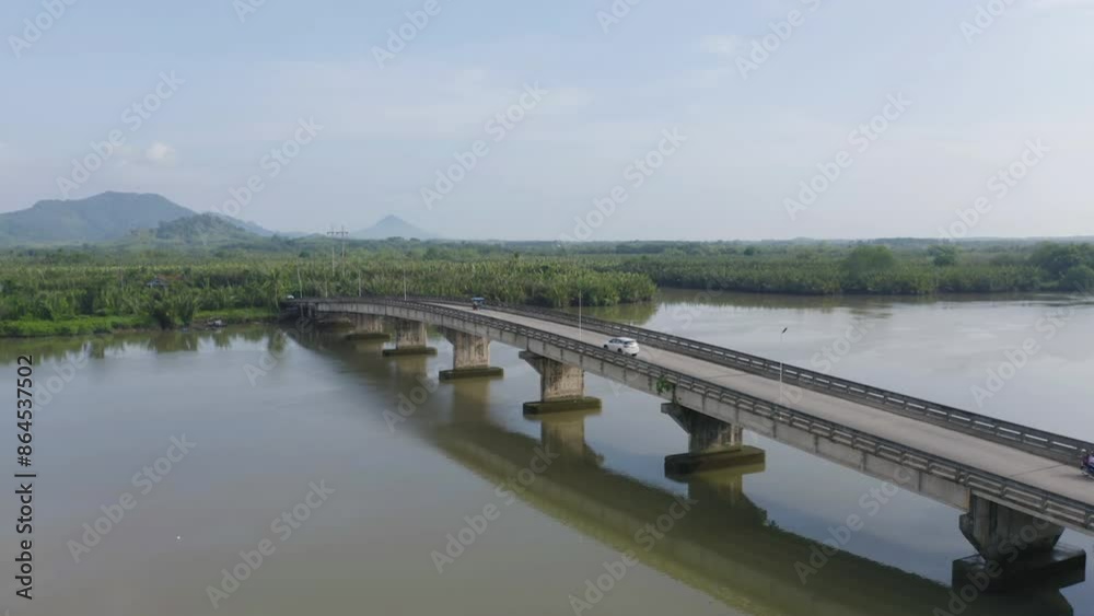 Aerial top view of a bridge with garden park with green mangrove forest trees, river, pond or lake. Nature landscape background, Thailand. Aerial top view of a bridge with garden park with green mangrove forest trees, river, pond or lake. Nature landscape background, Thailand.