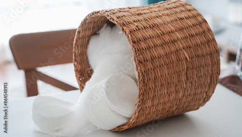 Billede på lærred Make-up remover cotton and cotton balls in a wicker basket on background