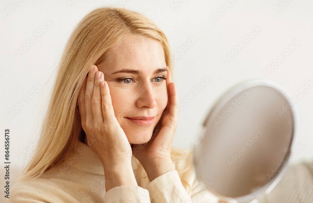 Natural Beauty. Mature Woman Looking At Mirror And Touching Face Natural Beauty. Mature Woman Looking At Mirror And Touching Face