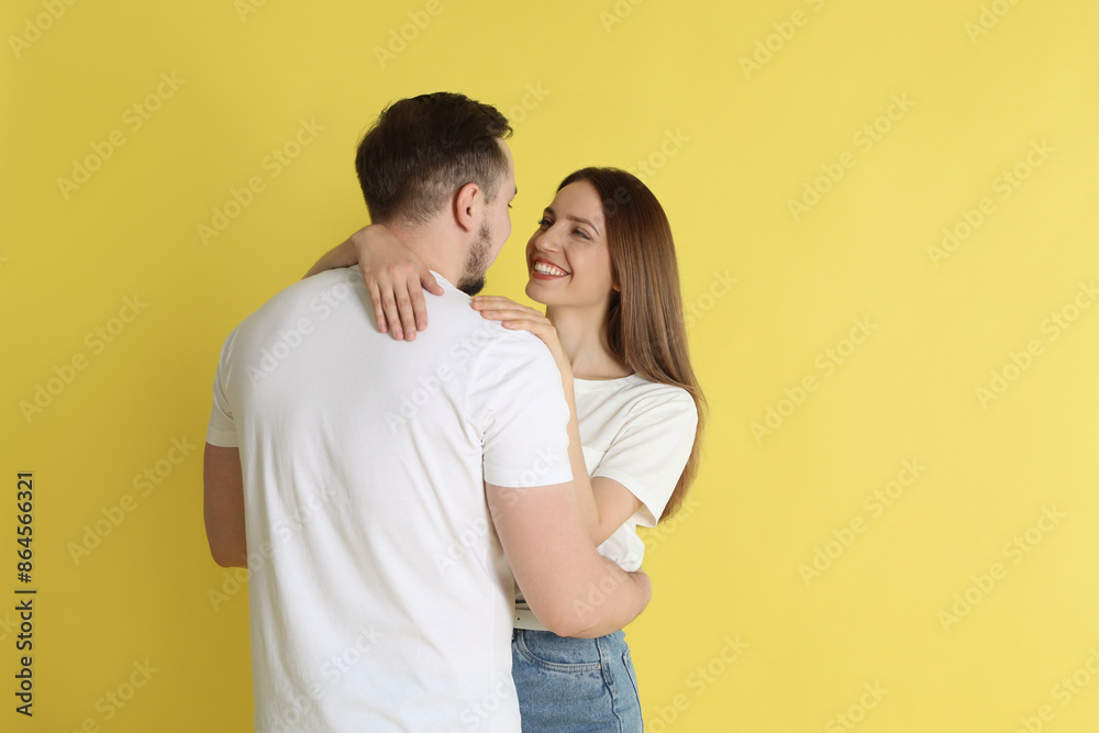 Happy couple hugging on yellow background. Strong relationship Happy couple hugging on yellow background. Strong relationship