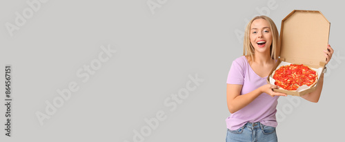 Happy young woman holding c...