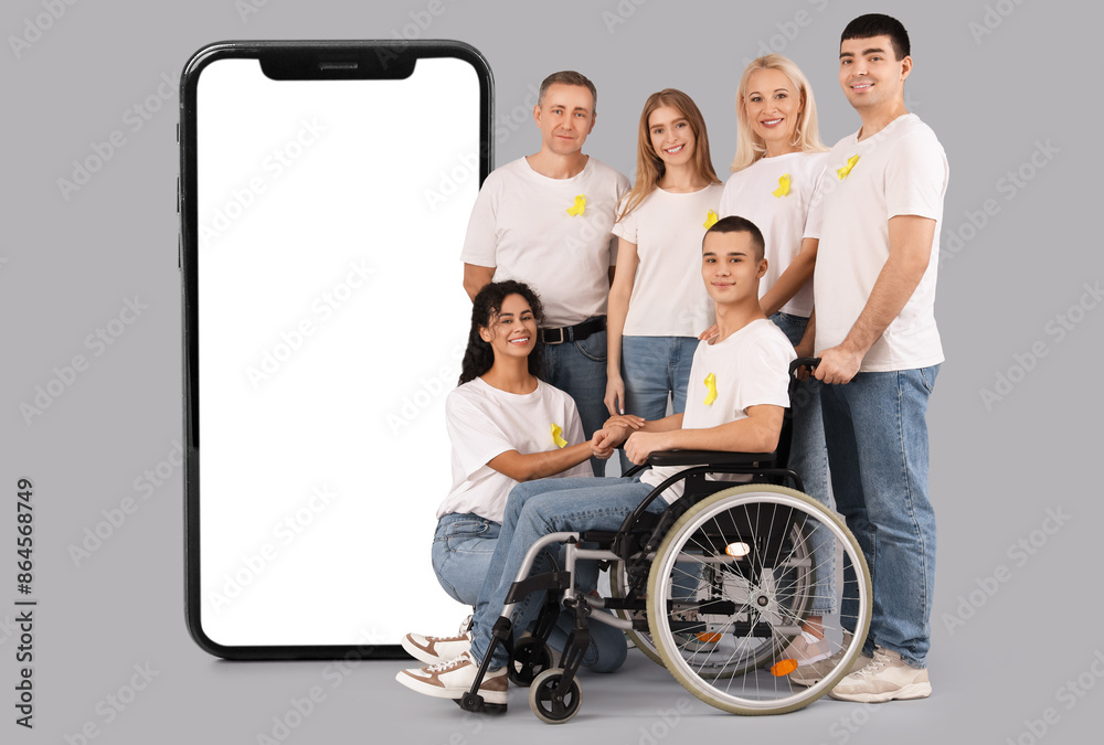 Young man in wheelchair and people with yellow awareness ribbons on light background. World Cancer Day Young man in wheelchair and people with yellow awareness ribbons on light background. World Cancer Day