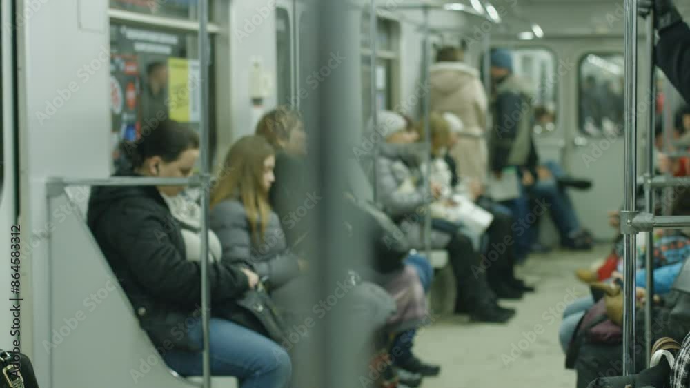 People go to work in the subway train in the morning. Metro car with passengers.