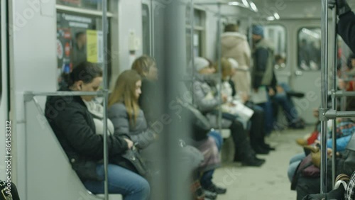 People go to work in the subway train in the morning. Metro car with passengers.