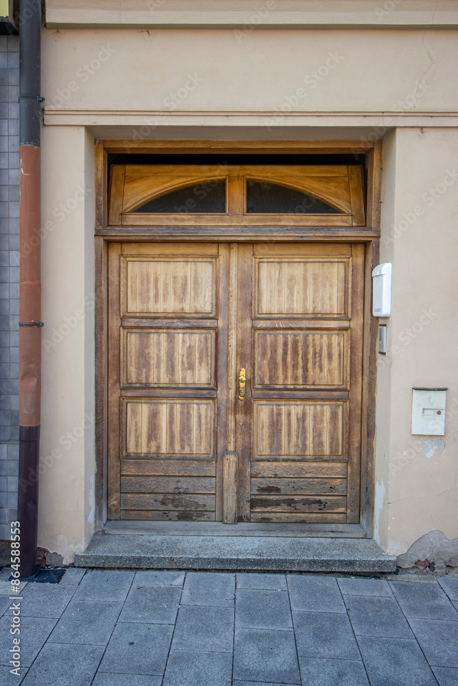 Old wooden entrance door to a tenement house Old wooden entrance door to a tenement house