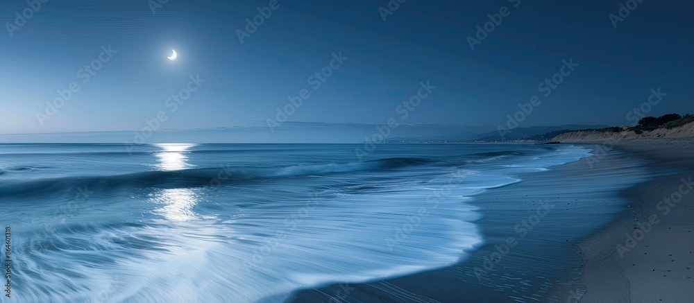 Fototapeta premium Capture a serene beach scene under a full moon with soft waves through a long exposure for a stunning copy space image.