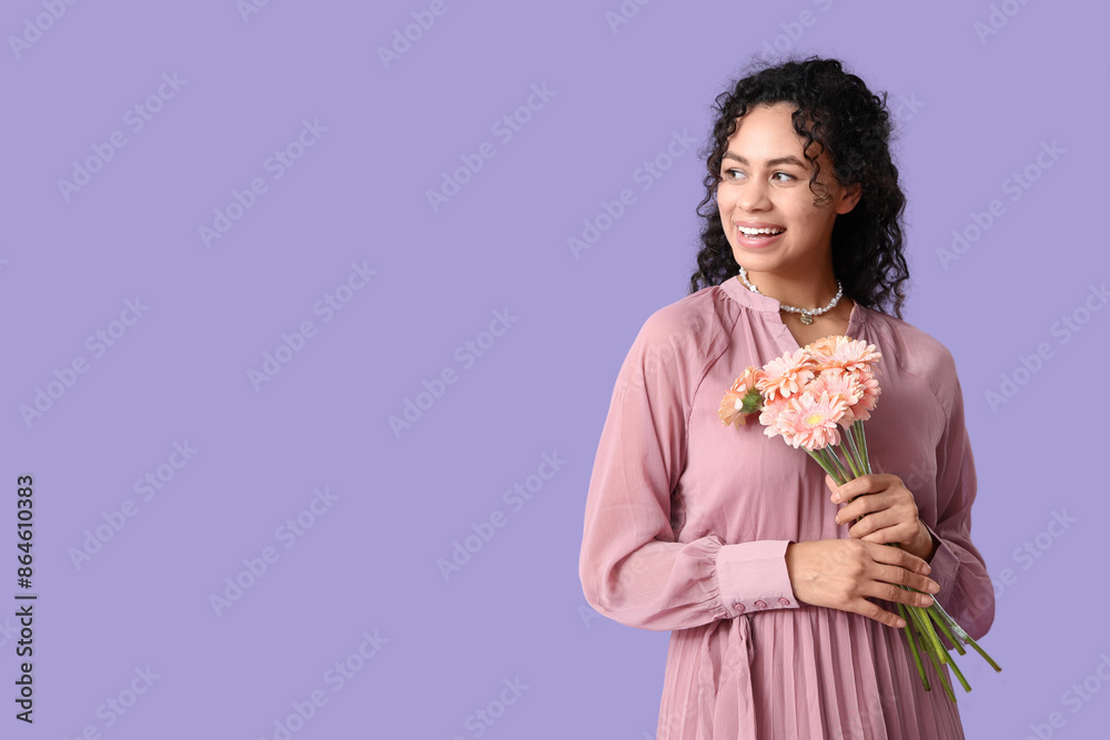 Beautiful young African-American woman with bouquet of gerbera flowers on lilac background. International Women's Day Beautiful young African-American woman with bouquet of gerbera flowers on lilac background. International Women's Day