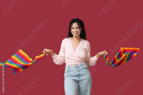 Smiling young woman holding...