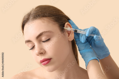 Young woman receiving fille...