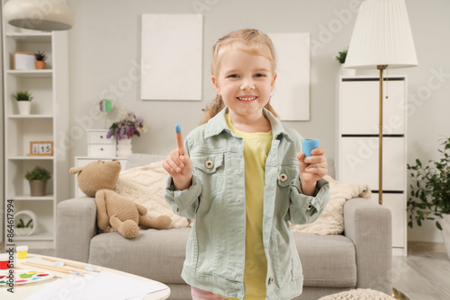 Cute little girl with paint...