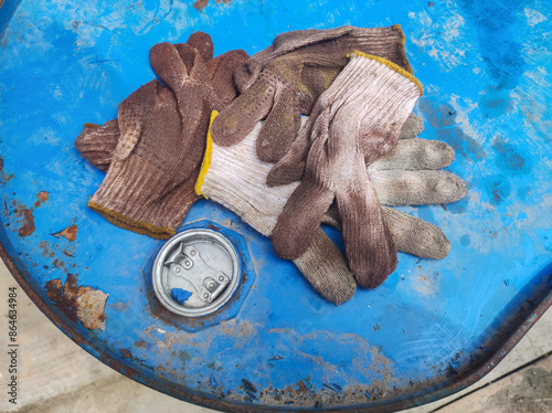 dirty workers' gloves contaminated with oil. concept photo of an example of B3 toxic waste photo