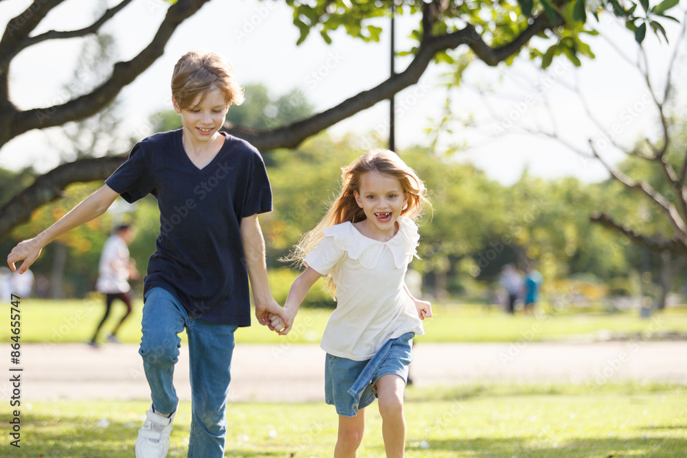 Lovely little children playing or running together at park. Lovely little children playing or running together at park.