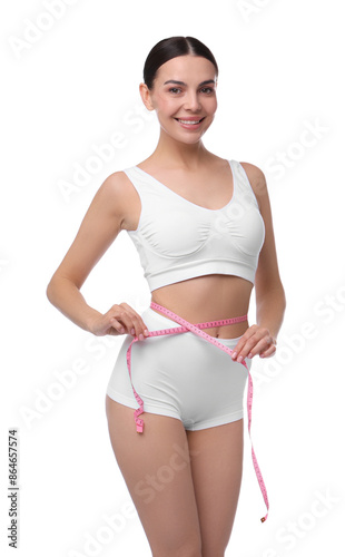 Diet and weight loss concept. Beautiful young woman with measuring tape showing her slim body against white background © New Africa