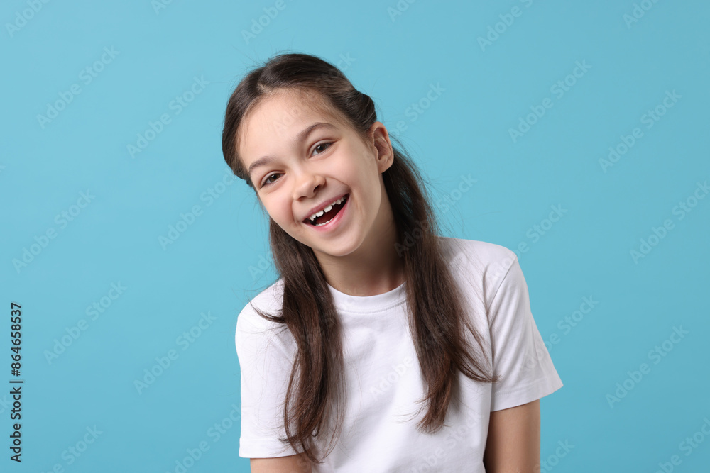 Portrait of happy girl on light blue background Portrait of happy girl on light blue background