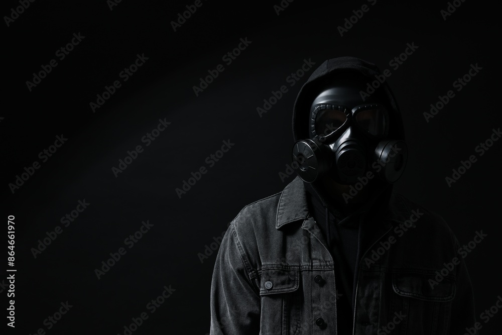 Man in gas mask on black background. Space for text Man in gas mask on black background. Space for text