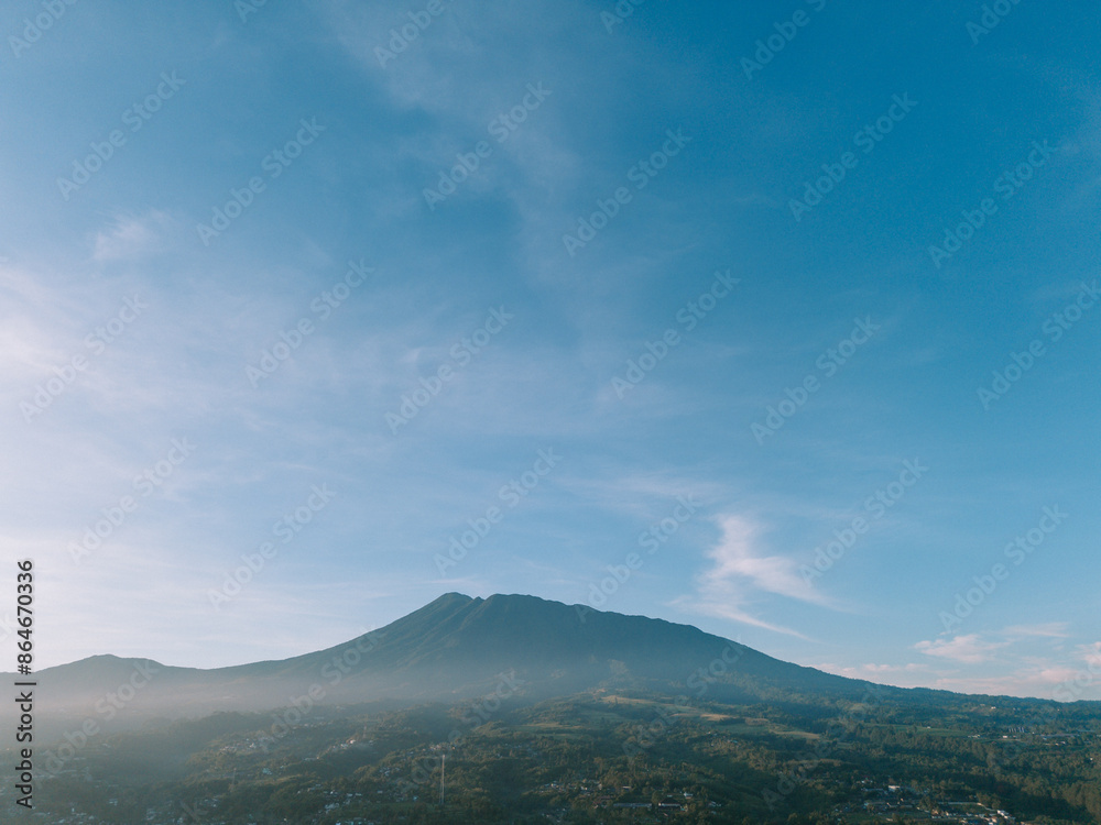 Morning view of Mount Gede with light mist and bright clouds, capturing serene and clear beauty Morning view of Mount Gede with light mist and bright clouds, capturing serene and clear beauty