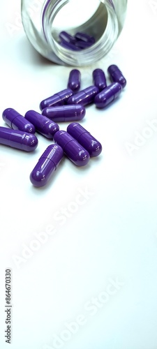 Pills and capsules spilling out of a toppled from pill bottle
 photo