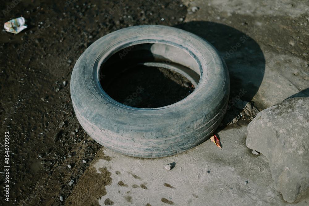 Old, used tire, showcasing signs of wear and tear, ideal for recycling or upcycling projects Old, used tire, showcasing signs of wear and tear, ideal for recycling or upcycling projects