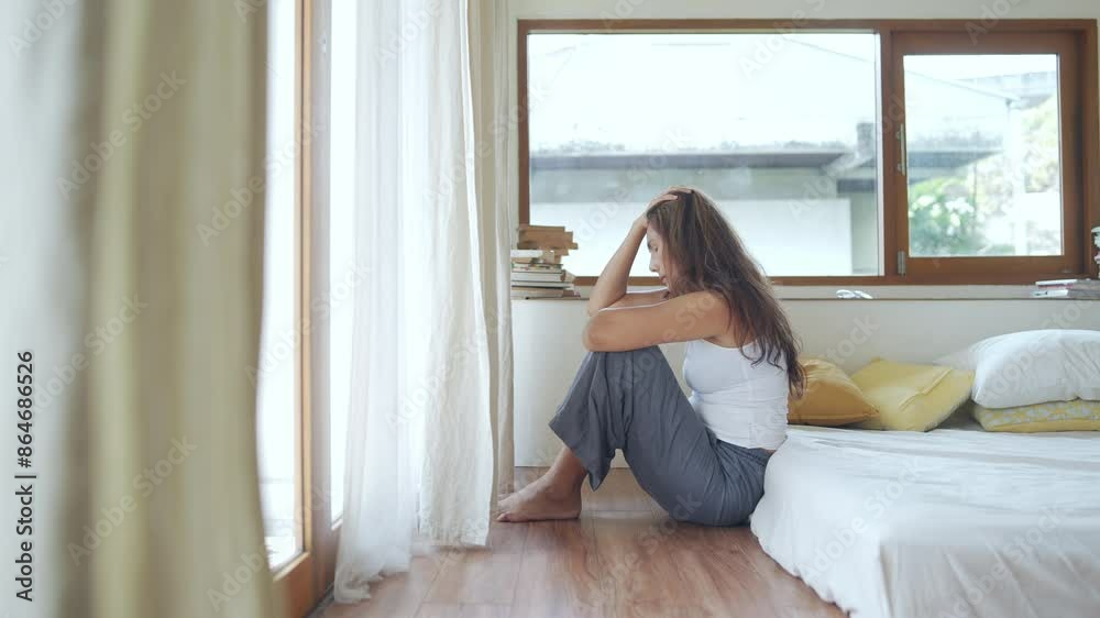 4K Depressed Asian mature woman sitting in bedroom and hugging herself with sadness. Loneliness middle aged woman living alone with negative emotion. People mental health and life problem concept. 4K Depressed Asian mature woman sitting in bedroom and hugging herself with sadness. Loneliness middle aged woman living alone with negative emotion. People mental health and life problem concept.
