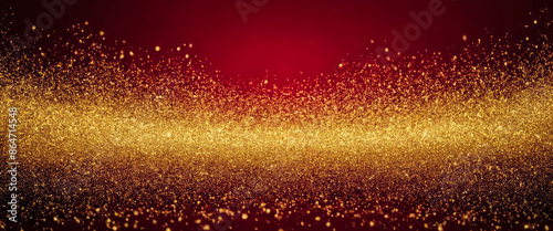 Abstract background with gold glitter particles scattered on a deep red background