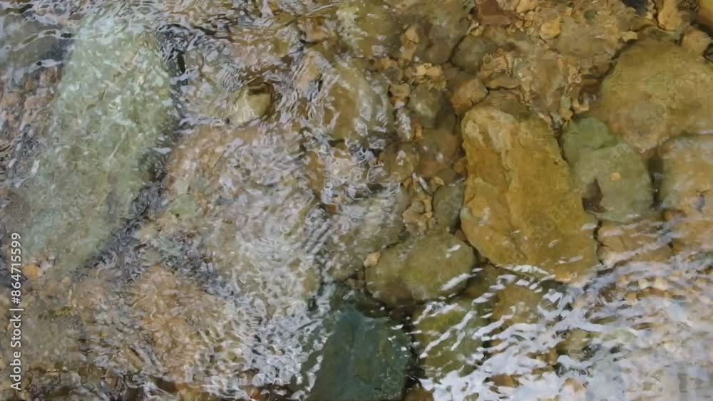 Top View.The water reflection texture background has brown rocks underwater. Top View.The water reflection texture background has brown rocks underwater.