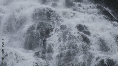 Landscapes.Waterfalls cascade down quickly through black rocks.
