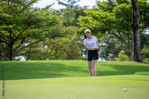 Professional woman golfer teeing golf in golf tournament competition at golf course for winner  © APstudio