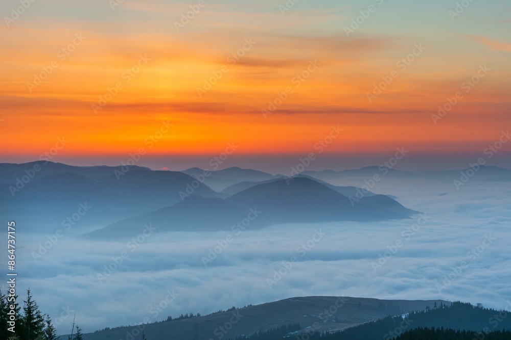 Dawn in the Ukrainian Carpathians with fog on the mountain slopes Dawn in the Ukrainian Carpathians with fog on the mountain slopes