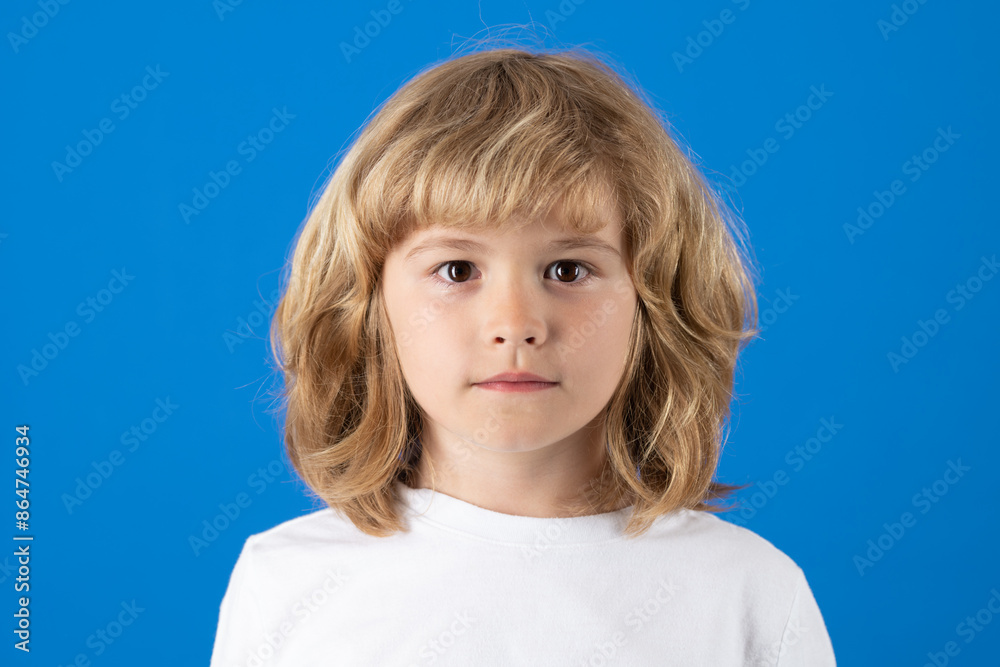Studio portrait of cute kid looking forward on blue isolated background. Studio portrait of cute kid looking forward on blue isolated background.