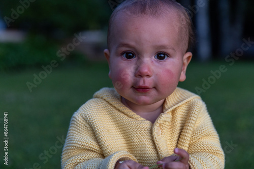 Toddler girl outside at sunset looks towards camera - cute 