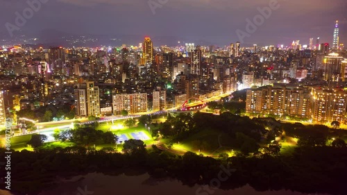 Night skyline of Taipei, the capital city of Taiwan, with Guting Bikeway Bridge Observation Deck by an elevated expressway and 101 Tower among high rise buildings and dazzling lights in Xinyi District
