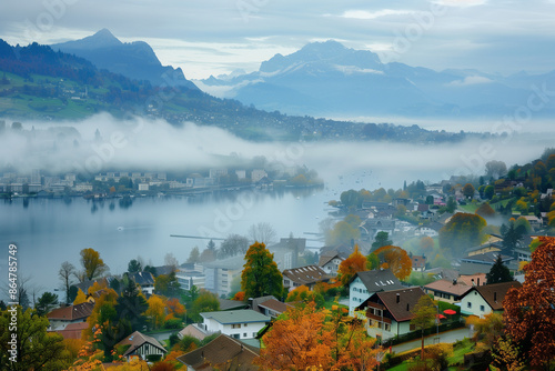 Gorgeous autumn view on suburb of Stansstad city and Lucerne lake with mountaines and fog photo