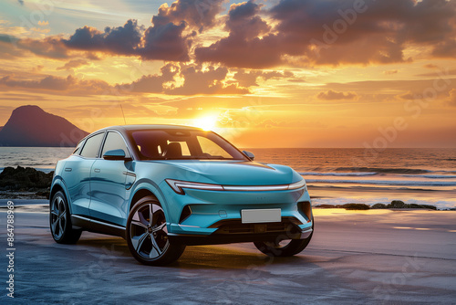 Blue compact SUV car with sport and modern design parked on concrete road by sea beach at sunset. New shiny SUV car drive for travel on summer vacations with road trip. Front view of electric car