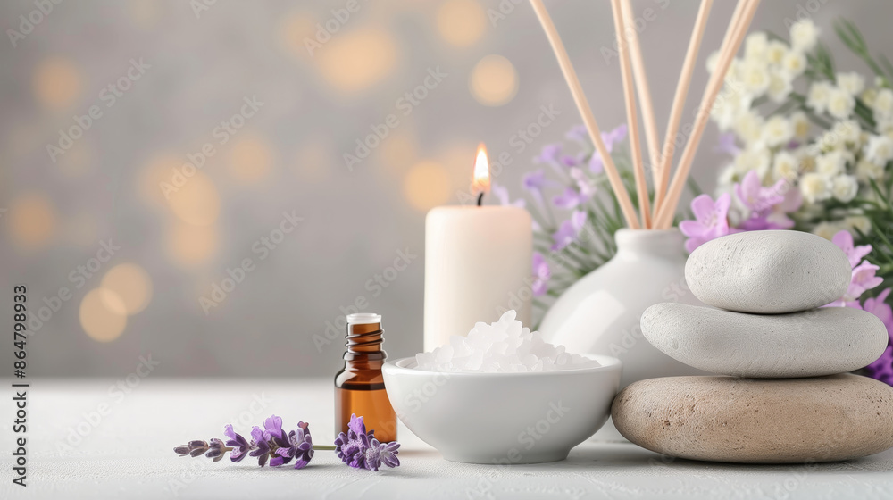 Relaxing spa scene with essential oils, aromatic candle, and purple flowers for a calming and rejuvenating experience.