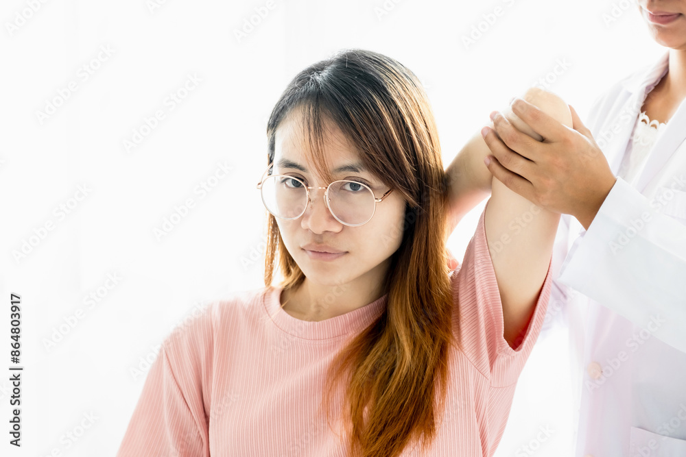Female doctor hand rehab physical therapy by extending the pain shoulder of a patient. treatment with stretch exercises Female doctor hand rehab physical therapy by extending the pain shoulder of a patient. treatment with stretch exercises