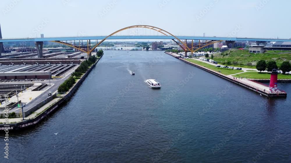 4K Aerial View Of Passenger Cruise Boats Passing Under The Hoan Bridge In Downtown Milwaukee, Wisconsin; Sightseeing, Travel, Vacation Activities. 4K Aerial View Of Passenger Cruise Boats Passing Under The Hoan Bridge In Downtown Milwaukee, Wisconsin; Sightseeing, Travel, Vacation Activities.