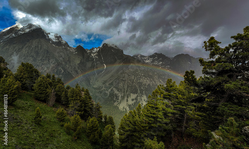 Amazing rainbow in front of the Monviso mountain range, taken from a viewpoint located at 2400 m above sea level in the Monviso natural park, Val Vallanta, Piedmont, Italy. June.
 photo