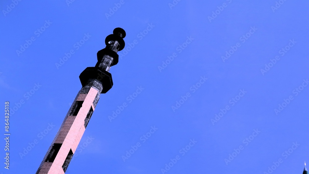 Fototapeta premium A mosque and minaret with bright blue sky background, moslem wallpaper concept