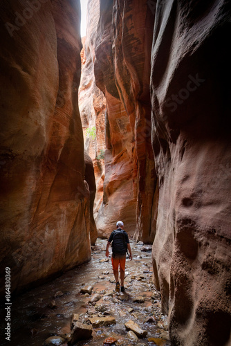 Photography Young man walking through a scenic slot canyon near Zion National Park in Utah