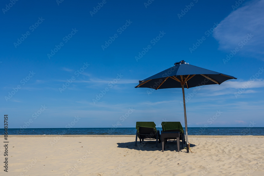 Blue umbrella and chair around beach sea ocean with blue sky for travel vacation Blue umbrella and chair around beach sea ocean with blue sky for travel vacation