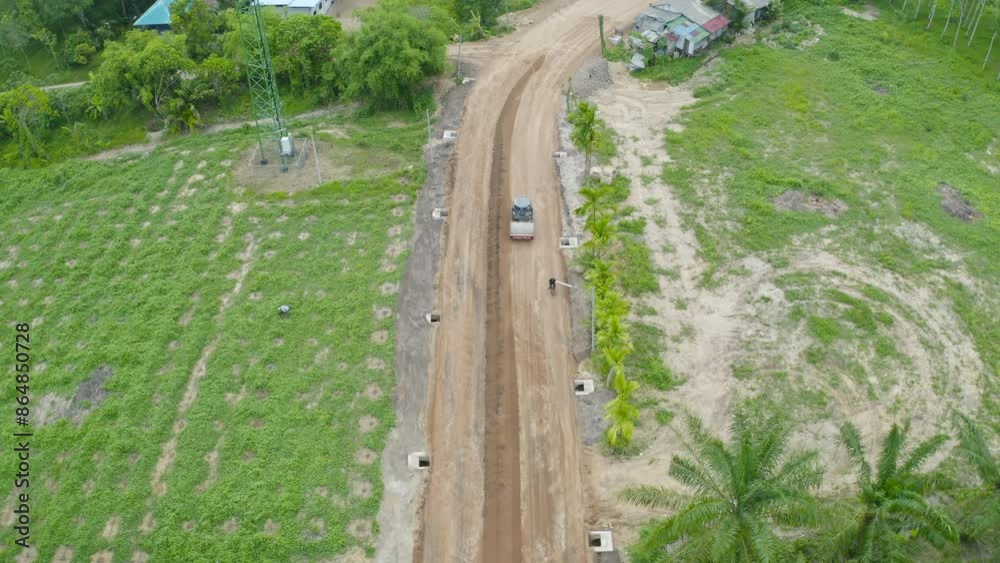 Aerial view of construction tractor car, bulldozer, or backhoe digging road or street in traffic transportation and agriculture concept. Engine working in urban city town. Aerial view of construction tractor car, bulldozer, or backhoe digging road or street in traffic transportation and agriculture concept. Engine working in urban city town.
