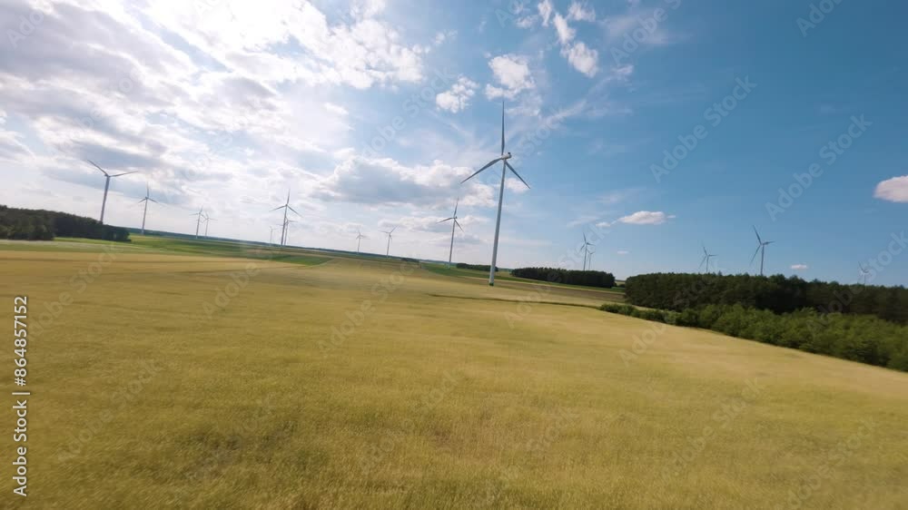 Wind turbine farm and sunny warm day, aerial FPV view Wind turbine farm and sunny warm day, aerial FPV view